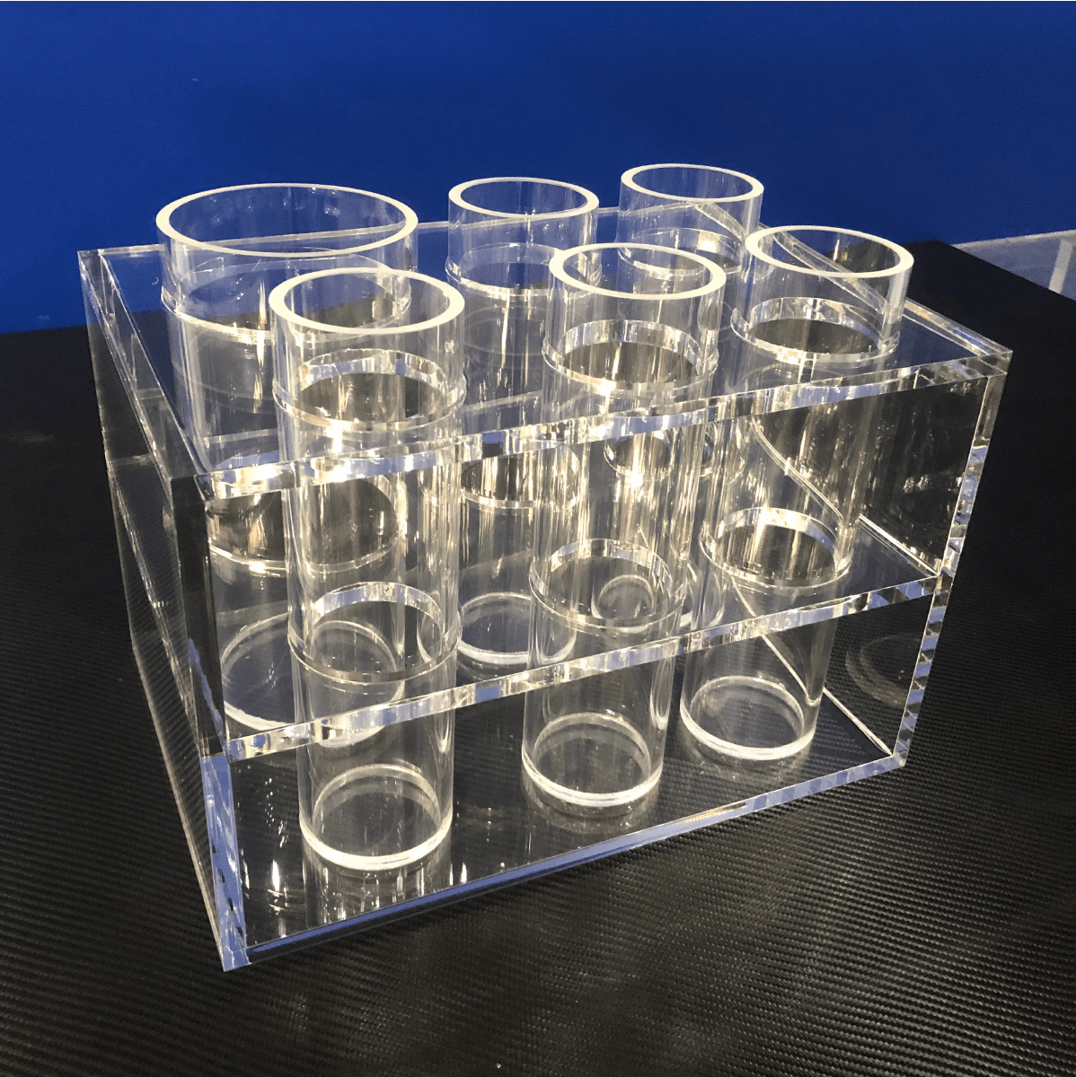 a clear plastic container with clear tubes for acrylic fabrication